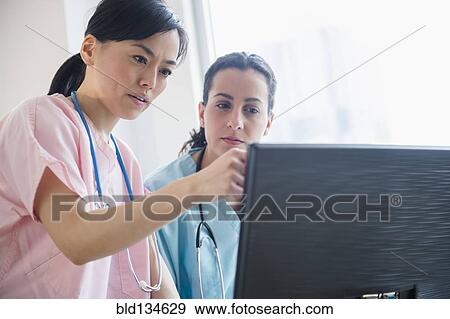Nurses working together in hospital View Large Photo Image Stock Photo - Nurses working together in hospital. Fotosearch