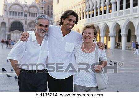 Parents and son walking in St. Mark's Square, Venice, Veneto, Italy View Large Photo Image Picture - Parents and son walking in St. Mark's Square, Venice, Veneto, Italy. Fotosearch