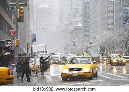 People hailing taxis on city street, New York City, New York, United States View Large Photo Image Stock Image - People hailing taxis on city street, New York City, New York, United States. Fotosearch