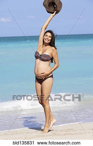 Pregnant Hispanic woman cheering on beach View Large Photo Image Stock Image - Pregnant Hispanic woman cheering on beach. Fotosearch