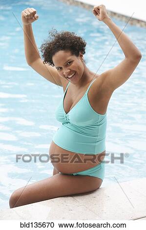 Pregnant woman cheering in swimming pool View Large Photo Image Stock Image - Pregnant woman cheering in swimming pool. Fotosearch