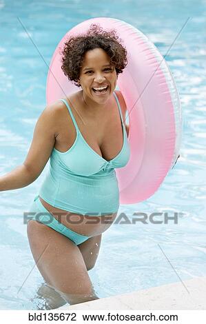 Pregnant woman cheering in swimming pool View Large Photo Image Stock Image - Pregnant woman cheering in swimming pool. Fotosearch