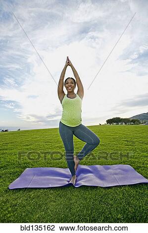 Pregnant woman practicing yoga in park View Large Photo Image Stock Image - Pregnant woman practicing yoga in park. Fotosearch