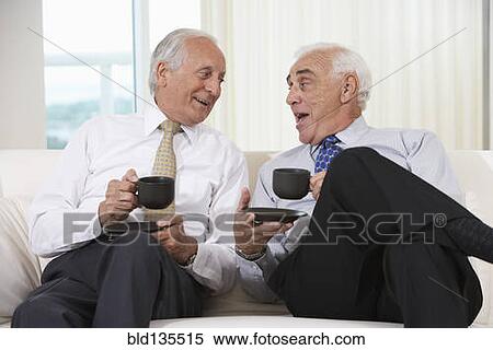 Senior businessmen having coffee on sofa View Large Photo Image Stock Photography - Senior businessmen having coffee on sofa. Fotosearch
