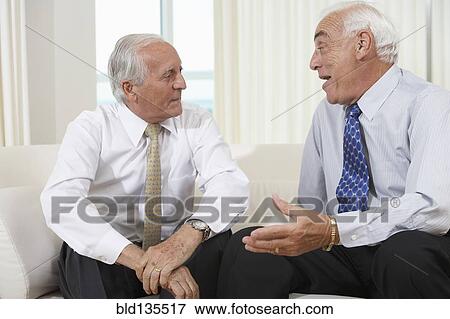 Senior businessmen talking on sofa View Large Photo Image Stock Photo - Senior businessmen talking on sofa. Fotosearch