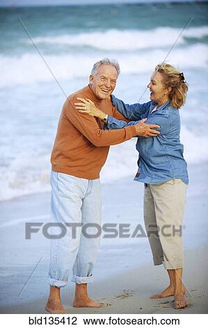 Senior Caucasian couple hugging on beach View Large Photo Image Stock Image - Senior Caucasian couple hugging on beach. Fotosearch