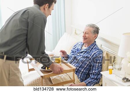 Senior Caucasian man having breakfast in bed View Large Photo Image Stock Photo - Senior Caucasian man having breakfast in bed. Fotosearch