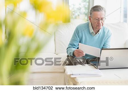 Senior Caucasian man paying bills online View Large Photo Image Stock Image - Senior Caucasian man paying bills online. Fotosearch