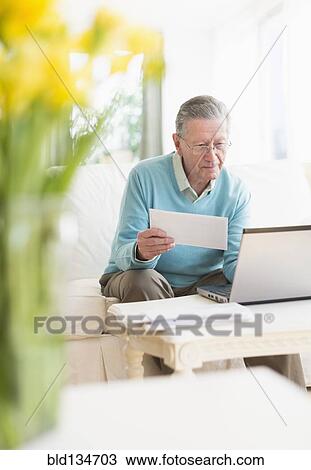 Senior Caucasian man paying bills online View Large Photo Image Stock Image - Senior Caucasian man paying bills online. Fotosearch