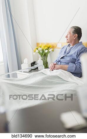 Senior Caucasian man sitting in hospital bed View Large Photo Image Stock Image - Senior Caucasian man sitting in hospital bed. Fotosearch