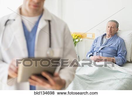 Stock Photo - Senior Caucasian man sitting in hospital bed. Fotosearch