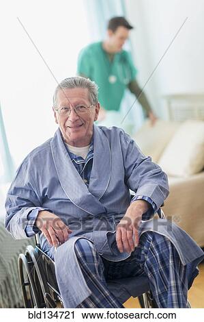 Stock Image - Senior Caucasian man smiling in wheelchair. Fotosearch