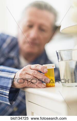 Senior Caucasian man taking medication View Large Photo Image Stock Photography - Senior Caucasian man taking medication. Fotosearch