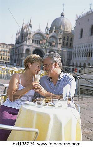 Senior couple eating at sidewalk cafe, St. Mark's Square, Venice, Veneto, Italy View Large Photo Image Picture - Senior couple eating at sidewalk cafe, St. Mark's Square, Venice, Veneto, Italy. Fotosearch