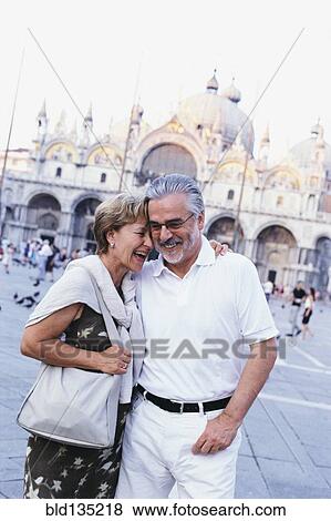 Stock Photo - Senior couple hugging in St. Mark's Square, Venice, Veneto, Italy. Fotosearch