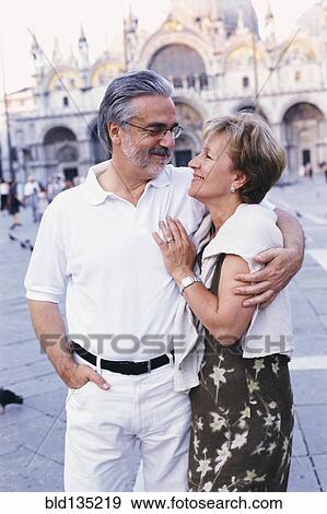 Senior couple hugging in St. Mark's Square, Venice, Veneto, Italy View Large Photo Image Stock Photo - Senior couple hugging in St. Mark's Square, Venice, Veneto, Italy. Fotosearch