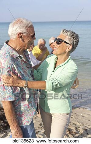 Senior couple hugging on beach View Large Photo Image Stock Image - Senior couple hugging on beach. Fotosearch