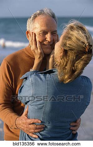Senior couple hugging on beach View Large Photo Image Stock Photograph - Senior couple hugging on beach. Fotosearch