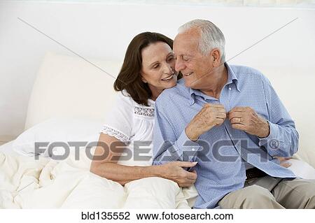 Senior couple hugging on bed View Large Photo Image Stock Image - Senior couple hugging on bed. Fotosearch