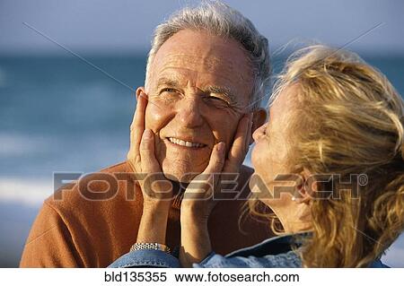 Senior couple relaxing on beach View Large Photo Image Stock Photography - Senior couple relaxing on beach. Fotosearch