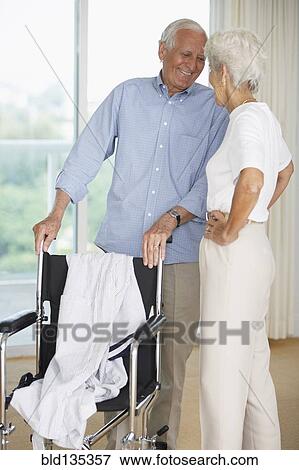 Senior couple smiling in hospital View Large Photo Image Stock Photo - Senior couple smiling in hospital. Fotosearch