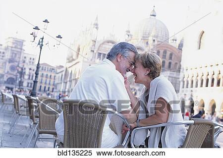 Senior couple touching foreheads at sidewalk cafe, St. Mark's Square, Venice, Veneto, Italy View Large Photo Image Stock Photography - Senior couple touching foreheads at sidewalk cafe, St. Mark's Square, Venice, Veneto, Italy. Fotosearch