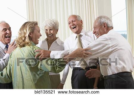 Senior friends laughing together View Large Photo Image Stock Image - Senior friends laughing together. Fotosearch