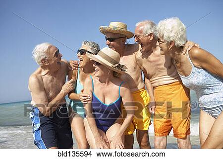 Picture - Senior friends smiling on beach. Fotosearch
