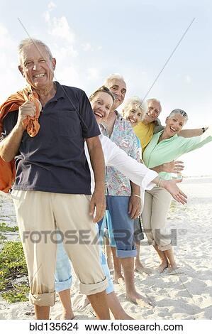 Senior friends smiling on beach View Large Photo Image Picture - Senior friends smiling on beach. Fotosearch