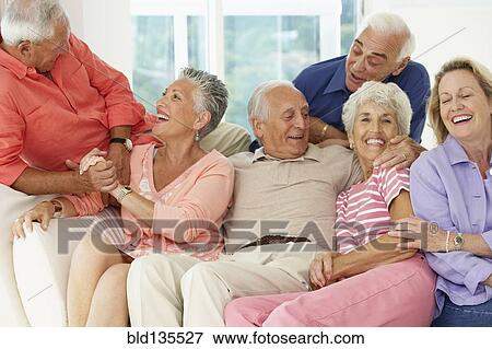Senior friends talking in living room View Large Photo Image Stock Photo - Senior friends talking in living room. Fotosearch