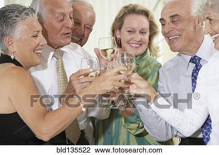 Senior friends toasting each other View Large Photo Image Stock Image - Senior friends toasting each other. Fotosearch