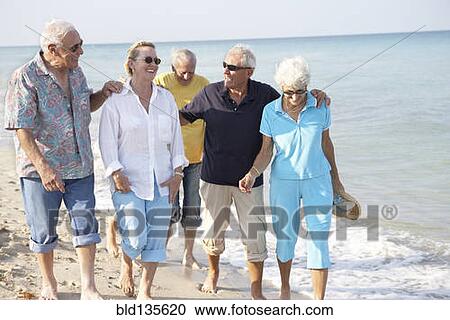 Senior friends walking on beach View Large Photo Image Stock Image - Senior friends walking on beach. Fotosearch