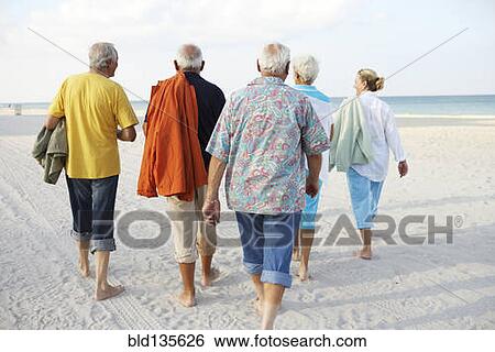 Senior friends walking on beach View Large Photo Image Stock Photograph - Senior friends walking on beach. Fotosearch