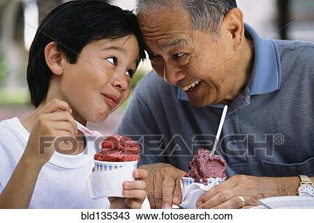 Senior man and grandson eating ice cream outdoors View Large Photo Image Stock Image - Senior man and grandson eating ice cream outdoors. Fotosearch