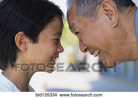 Senior man and grandson smiling outdoors View Large Photo Image Picture - Senior man and grandson smiling outdoors. Fotosearch