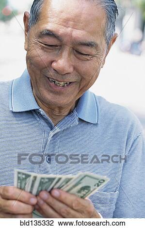 Senior man counting money outdoors View Large Photo Image Stock Image - Senior man counting money outdoors. Fotosearch