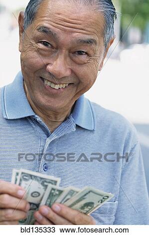 Senior man counting money outdoors View Large Photo Image Stock Image - Senior man counting money outdoors. Fotosearch