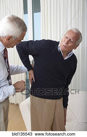 Senior man seeing doctor about back pain View Large Photo Image Stock Image - Senior man seeing doctor about back pain. Fotosearch