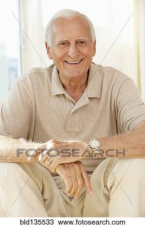 Senior man sitting on sofa View Large Photo Image Stock Image - Senior man sitting on sofa. Fotosearch
