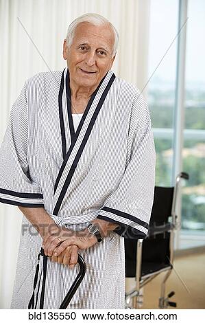 Senior man standing with cane View Large Photo Image Stock Image - Senior man standing with cane. Fotosearch