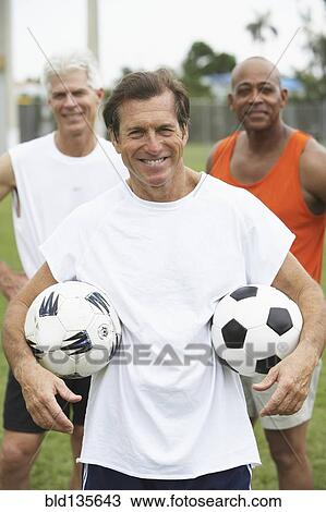 Senior men with soccer balls in park View Large Photo Image Stock Image - Senior men with soccer balls in park. Fotosearch