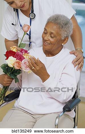 Senior patient getting flowers in hospital View Large Photo Image Stock Photo - Senior patient getting flowers in hospital. Fotosearch
