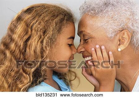 Senior woman and granddaughter touching noses View Large Photo Image Stock Image - Senior woman and granddaughter touching noses. Fotosearch