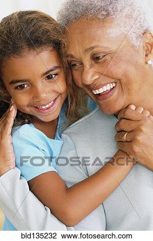 Senior woman and granddaughter touching noses View Large Photo Image Stock Image - Senior woman and granddaughter touching noses. Fotosearch