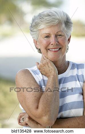 Senior woman smiling outdoors View Large Photo Image Stock Photo - Senior woman smiling outdoors. Fotosearch