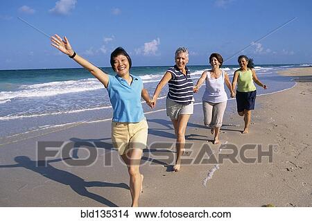 Senior women running on beach View Large Photo Image Picture - Senior women running on beach. Fotosearch