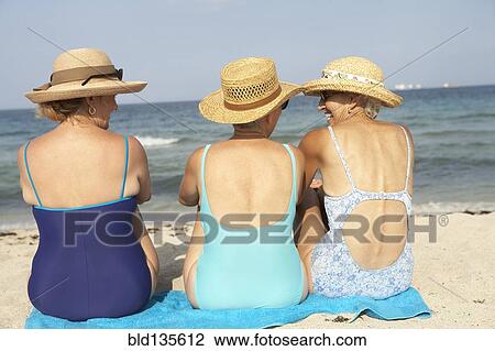 Senior women sitting on beach View Large Photo Image Stock Image - Senior women sitting on beach. Fotosearch