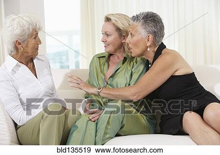 Senior women talking on sofa View Large Photo Image Stock Photo - Senior women talking on sofa. Fotosearch