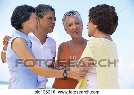 Senior women talking outdoors View Large Photo Image Stock Photograph - Senior women talking outdoors. Fotosearch
