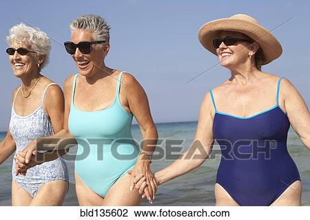 Senior women walking on beach View Large Photo Image Stock Image - Senior women walking on beach. Fotosearch